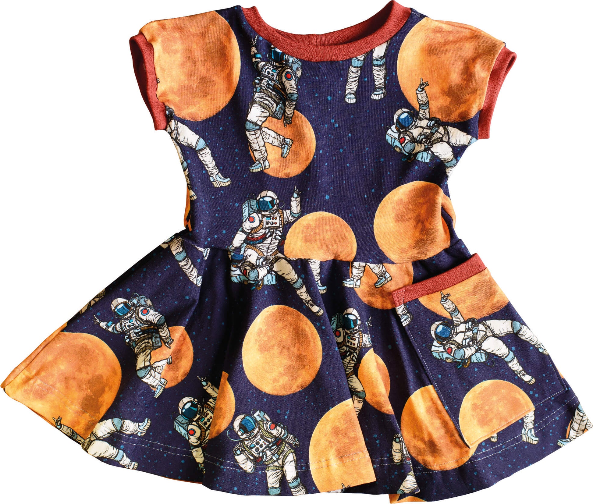 baby or child dress with a print showing an astronaut in space and the moon behind. the dress is in a skater style with a big flowy skirt and a pocket.