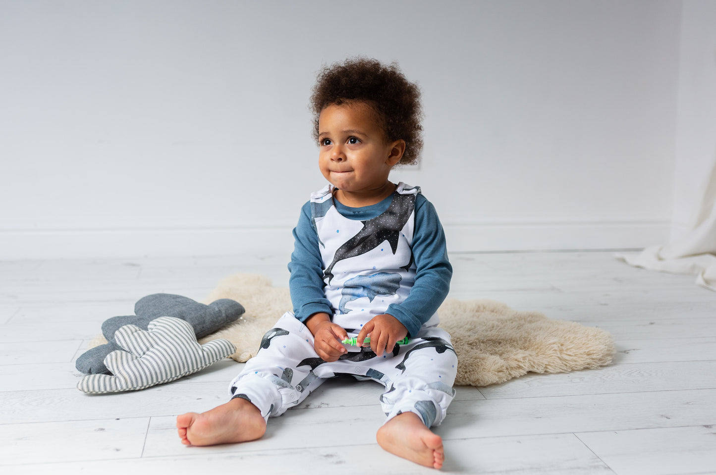 child wearing Organic whales print romper