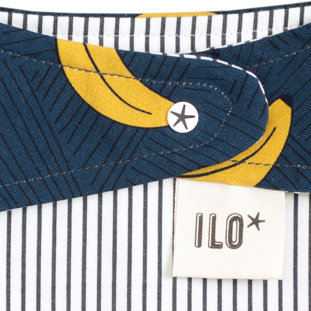 back of Bandana style taggy dribble bib on navy colour organic cotton jersey with bananas print