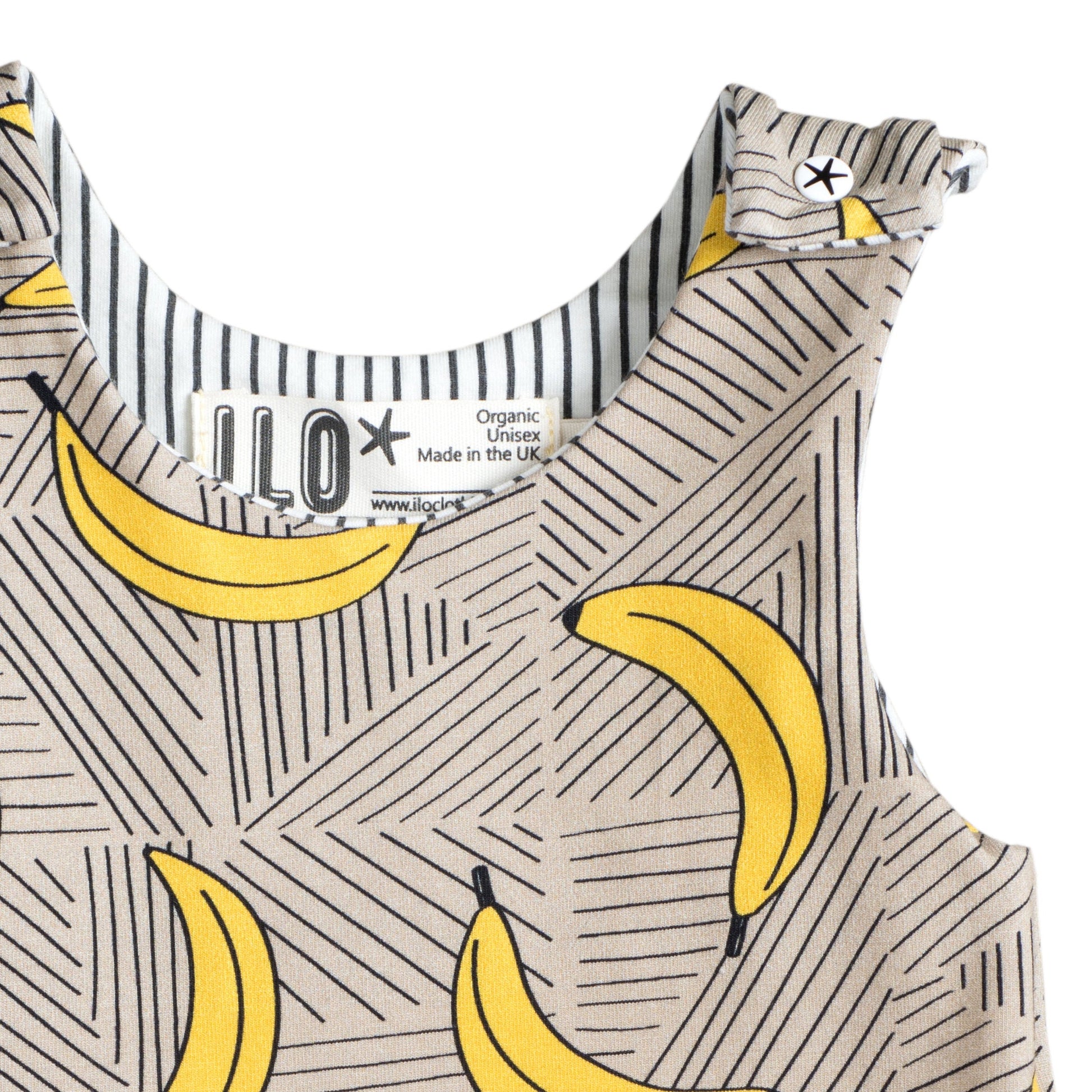 close up of the top of an ILO baby romper made with organic cotton with bananas and on a mushroom colour background